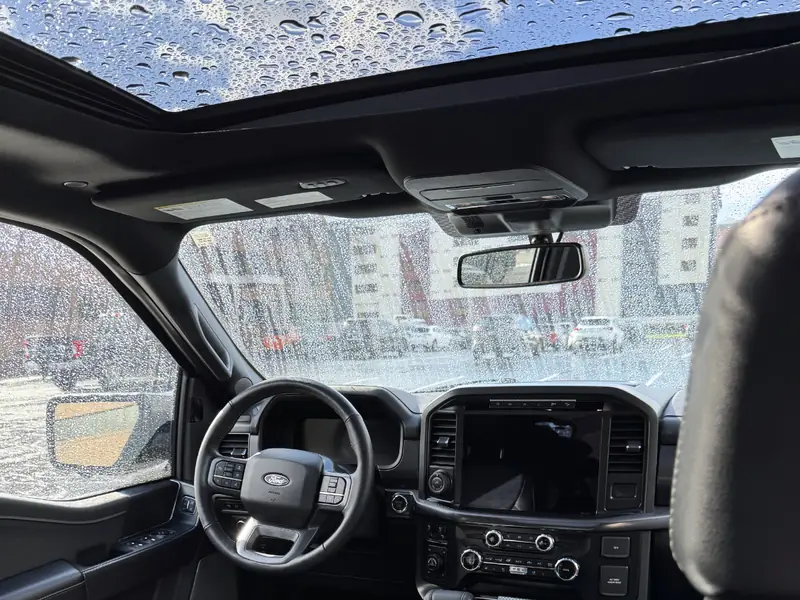 Ford interior showing windshield and sunroof from back seat