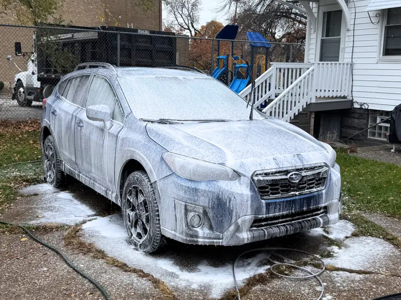 Subaru receiving professional foam wash treatment with premium products