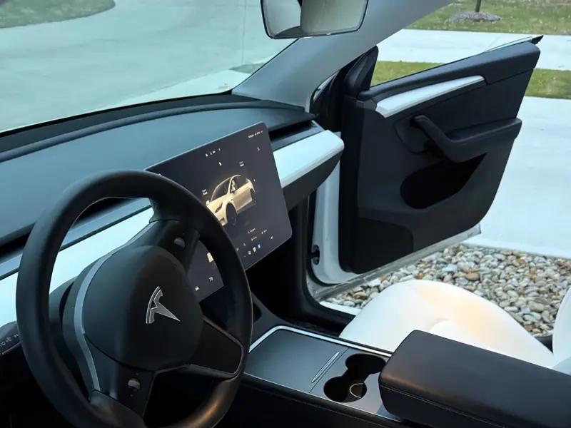 Tesla white interior dashboard and steering wheel detailed